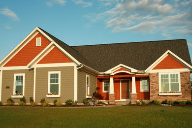 Mid-sized arts and crafts multicolored one-story mixed siding gable roof photo in Other
