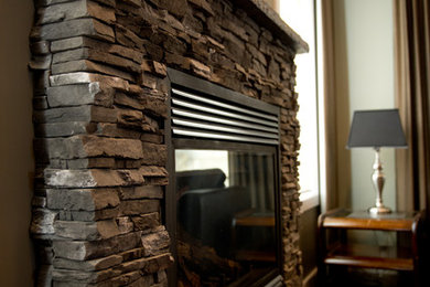 Mid-sized arts and crafts formal and open concept vinyl floor living room photo in Other with green walls, a standard fireplace, a stone fireplace and no tv