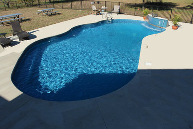 Pool fountain - mid-sized contemporary backyard custom-shaped pool fountain idea in Other with decking