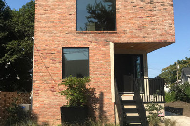 This is an example of a small modern full sun front yard landscaping in Cleveland.