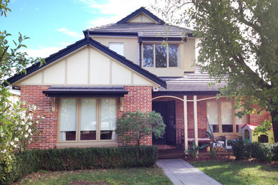 Photo of a contemporary exterior in Melbourne with a clipped gable roof.