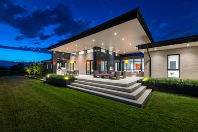 Minimalist backyard concrete patio photo in Denver with a fireplace and a roof extension