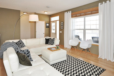 Living room - mid-sized contemporary open concept laminate floor living room idea in Minneapolis with green walls and a tv stand