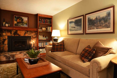 Example of a mid-sized classic enclosed dark wood floor and brown floor family room design in New York with a standard fireplace and a stone fireplace