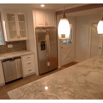 Pendant lights over island. Glass upper doors.