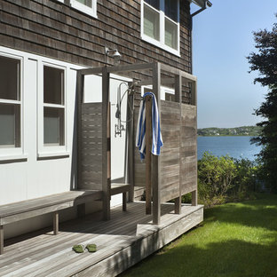 This is an example of a small beach style patio in New York with no cover and an outdoor shower.
