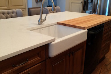 Country kitchen photo in Wilmington with a farmhouse sink and quartzite countertops