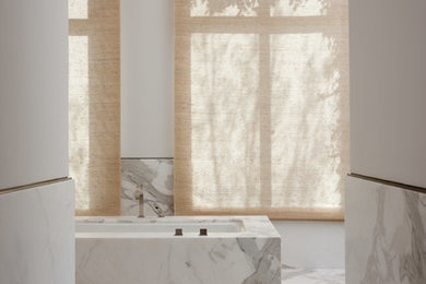 Inspiration for an expansive contemporary master bathroom in San Francisco with an undermount tub, white tile, stone slab, white walls and marble floors.
