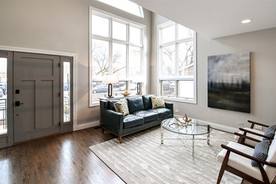 Living room - mid-sized country formal and open concept medium tone wood floor and brown floor living room idea in Chicago with gray walls, no fireplace and no tv