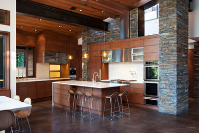 Inspiration for a large modern l-shaped concrete floor eat-in kitchen remodel in San Francisco with an undermount sink, flat-panel cabinets, medium tone wood cabinets, white backsplash, porcelain backsplash, stainless steel appliances and an island