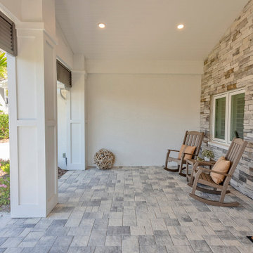 Shaded Outdoor Nook With Stone Tile Flooring and Rustic Rocking Chair Seating