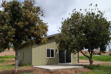 1960s one-story concrete fiberboard and board and batten house exterior photo in San Diego with a shingle roof