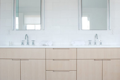 Inspiration for a contemporary white tile and stone tile bathroom remodel in New York with furniture-like cabinets, light wood cabinets and quartz countertops
