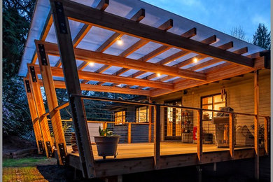 Deck - contemporary backyard deck idea in Seattle with a pergola