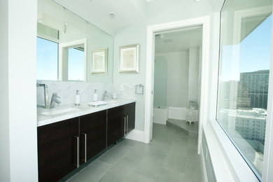 Design ideas for a mid-sized transitional master bathroom in San Francisco with a shower/bathtub combo, a one-piece toilet, white tile, porcelain tile, green walls, porcelain floors, flat-panel cabinets, black cabinets, an undermount sink, marble benchtops, grey floor and an open shower.