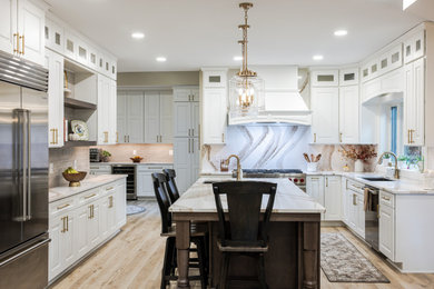 Example of a large minimalist l-shaped vinyl floor and beige floor eat-in kitchen design in Other with an undermount sink, raised-panel cabinets, white cabinets, quartz countertops, white backsplash, quartz backsplash, stainless steel appliances, an island and white countertops