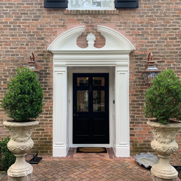 Traditional Brick Classic Home with White Trim and Black Shutters
