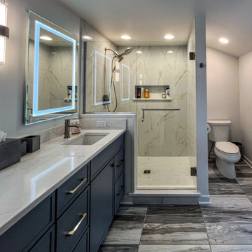Primary Suite Remodel with Blue Cabinetry and Calacatta Miraggio Duo Quartz