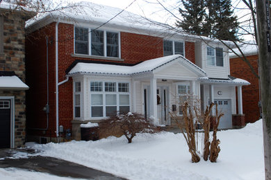 Mid-sized traditional multicolored two-story brick house exterior idea in Toronto with a hip roof