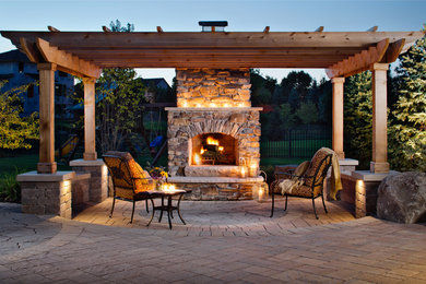 Example of a large transitional backyard concrete paver patio design in Chicago