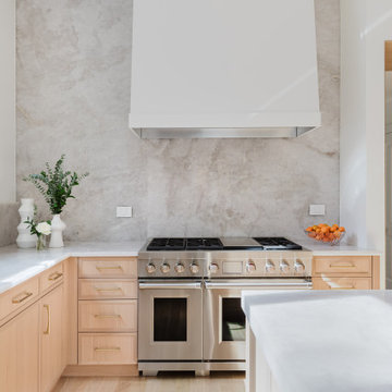 Modern Natural Kitchen With Stone Slab Backsplash and Pale Wood Cabinets