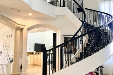 Photo of a medium sized contemporary curved mixed railing staircase in Miami.