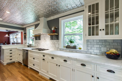 Mid-sized transitional galley light wood floor open concept kitchen photo in Kansas City with a peninsula, white cabinets, marble countertops, marble backsplash, stainless steel appliances, white countertops, a farmhouse sink and flat-panel cabinets