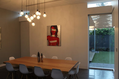 Large contemporary dining room in Adelaide with grey walls, concrete floors and no fireplace.