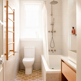 This is an example of a contemporary bathroom in Sydney with flat-panel cabinets, light wood cabinets, a corner tub, a shower/bathtub combo, white tile, a vessel sink, beige floor, a shower curtain, white benchtops, a single vanity and a floating vanity.