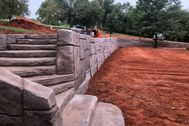 Expansive classic sloped garden in Oklahoma City with a retaining wall.