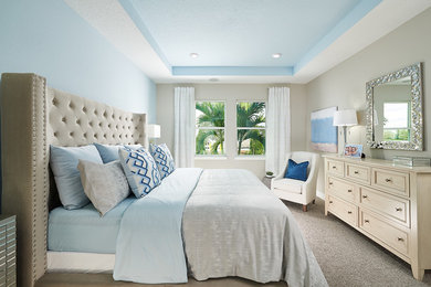 Photo of a modern master bedroom in Orlando with beige walls.