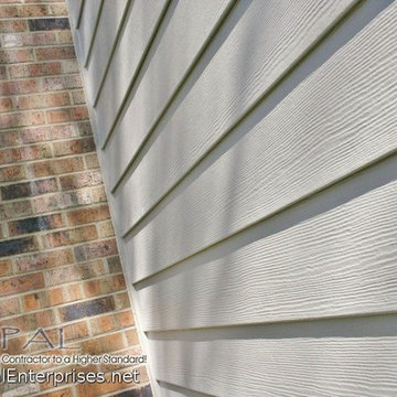 James Hardie Monterey Taupe Cedarmill Siding Next To A Brick Chimney