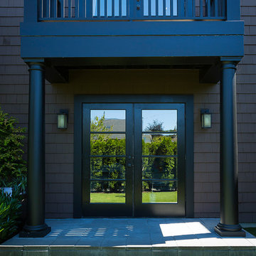 Dark columns frame mirrored door