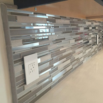 Modern Kitchen with Ebony Cabinet and Glass Tile Backsplash