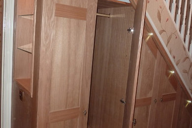 Bespoke built in oak under stair cupboards