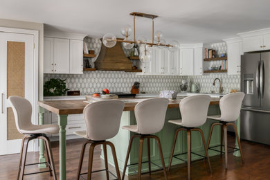 Example of a mid-sized transitional laminate floor and brown floor kitchen design in Philadelphia with an undermount sink, quartz countertops, multicolored backsplash, marble backsplash, stainless steel appliances, an island and gray countertops