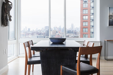Inspiration for a contemporary light wood floor and beige floor dining room remodel in New York with gray walls