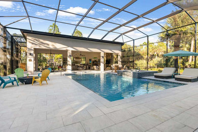 Pool house - large tropical backyard rectangular and concrete paver pool house idea in Miami