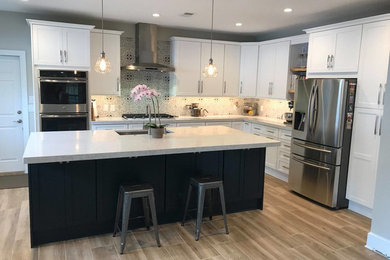 Inspiration for a mid-sized modern l-shaped porcelain tile and brown floor open concept kitchen remodel in Jacksonville with an undermount sink, shaker cabinets, white cabinets, quartz countertops, multicolored backsplash, stainless steel appliances, an island and white countertops
