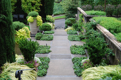 Design ideas for a mid-sized traditional front yard partial sun formal garden in Portland with a garden path.