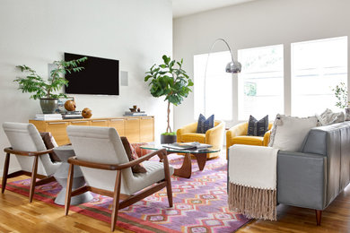 Living room - contemporary open concept medium tone wood floor and brown floor living room idea in Dallas with white walls, no fireplace and a wall-mounted tv