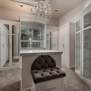 Primary Closet With Custom Built Ins and Island Seating