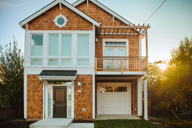 Mid-sized arts and crafts brown two-story wood exterior home photo in Portland with a shingle roof