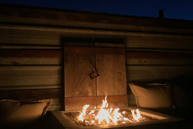 Inspiration for a small cottage concrete back porch remodel in San Luis Obispo with a fire pit and a pergola