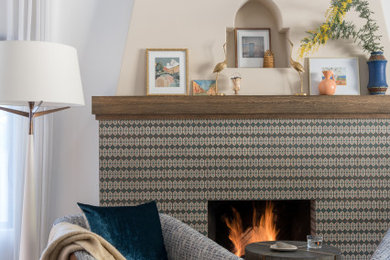 Inspiration for a mediterranean medium tone wood floor and brown floor living room remodel in Los Angeles with beige walls, a standard fireplace and a tile fireplace