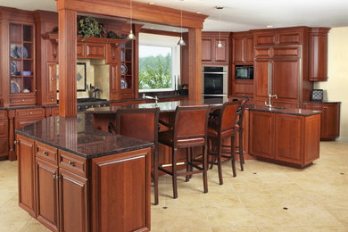 Inspiration for a large l-shaped linoleum floor eat-in kitchen remodel in Portland Maine with an undermount sink, raised-panel cabinets, medium tone wood cabinets, granite countertops, beige backsplash, ceramic backsplash, stainless steel appliances and an island