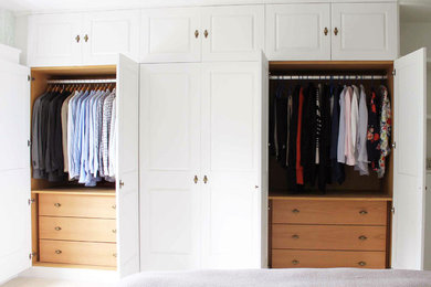 Design ideas for a medium sized classic master bedroom in Hertfordshire with green walls, carpet, no fireplace and beige floors.
