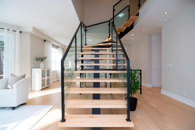 Example of a mid-sized trendy floating open and glass railing staircase design in Montreal