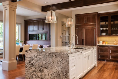 Huge elegant medium tone wood floor eat-in kitchen photo in Los Angeles with an undermount sink, shaker cabinets, dark wood cabinets, granite countertops, beige backsplash, subway tile backsplash, paneled appliances and an island
