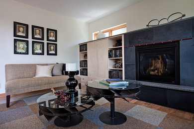 Inspiration for a mid-sized contemporary formal and open concept medium tone wood floor living room remodel in Seattle with white walls, a standard fireplace, a tile fireplace and no tv